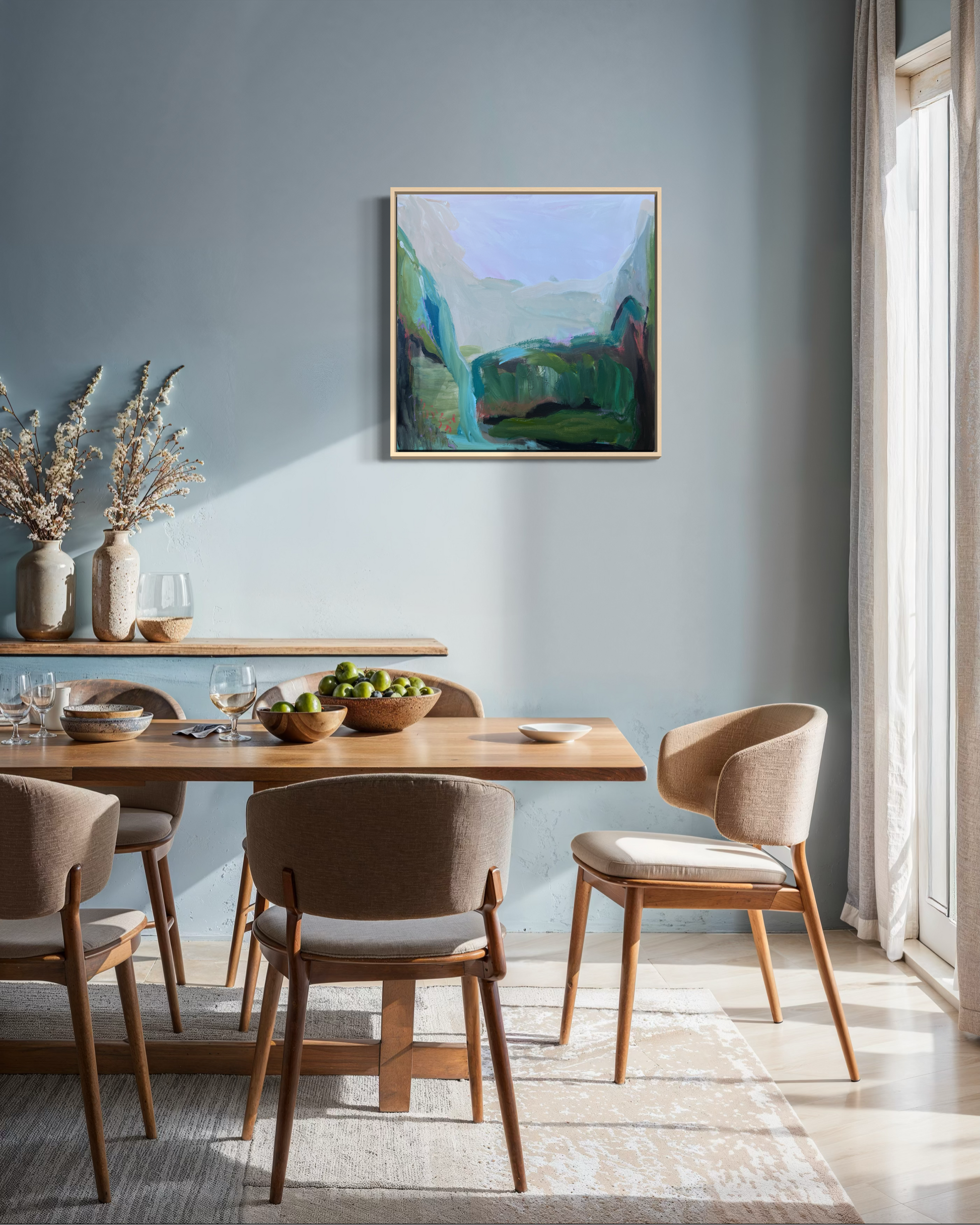 Dining room with wooden table and chairs, abstract painting on the wall, and natural light.