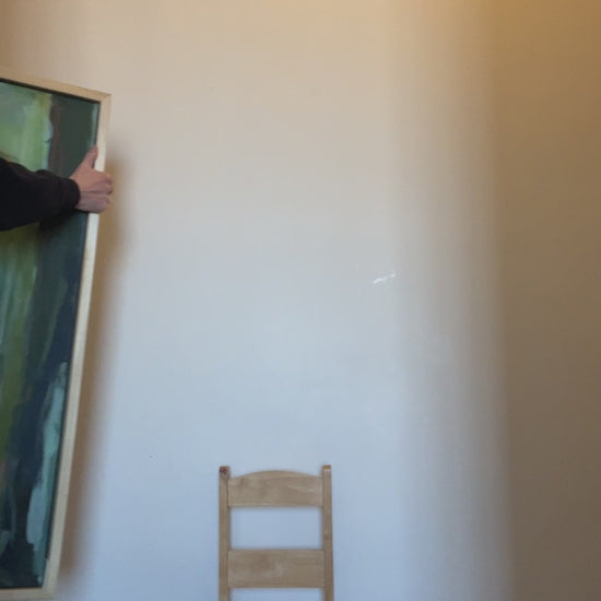 Video of artist bringing framed painting into view