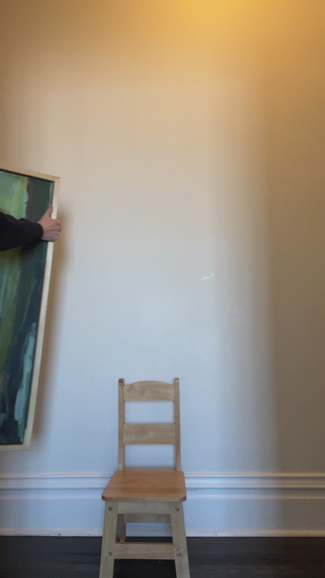 Video of artist bringing framed painting into view